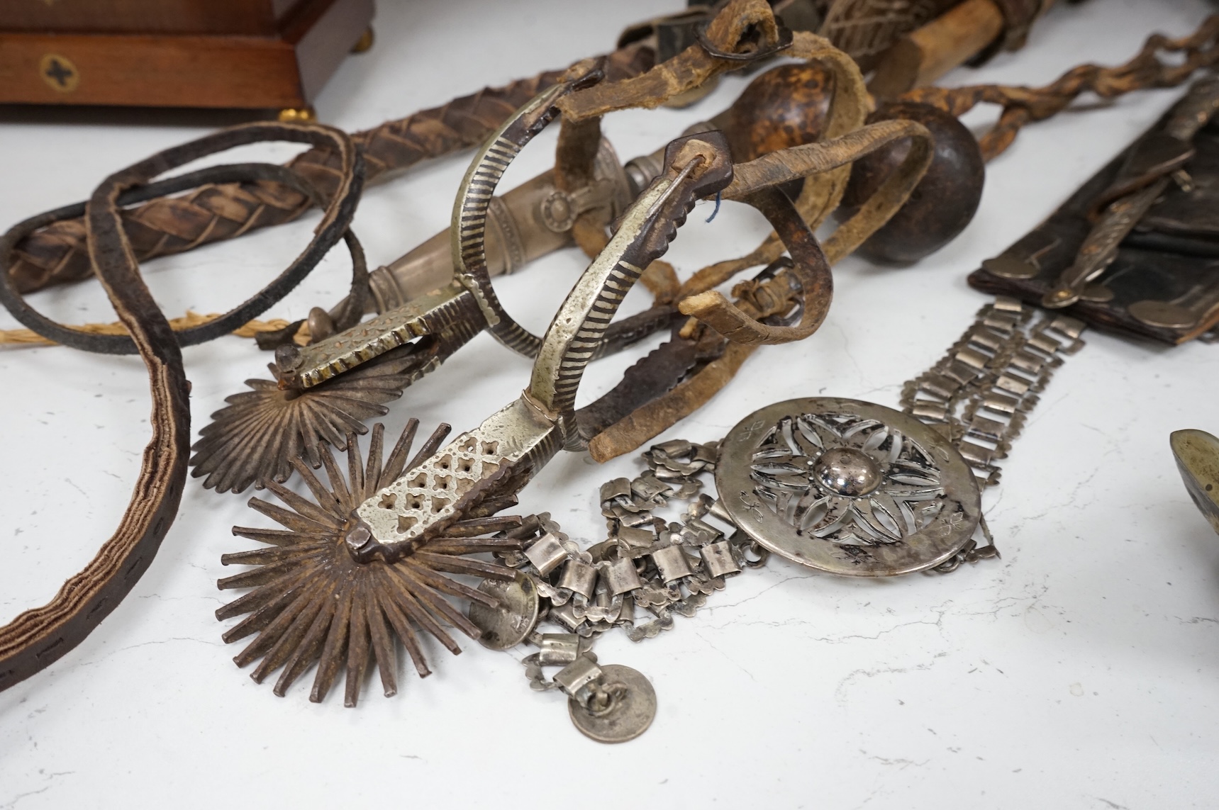 A group of Argentinian Gaucho spurs, bolas, bull whip, daggers and hanger, Longest 100cm